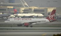 N641VA @ KLAX - Taxiing to gate on a foggy morning - by Todd Royer