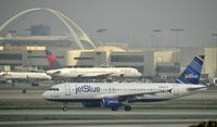 N805JB @ KLAX - Taxiing to gate on a foggy morning - by Todd Royer