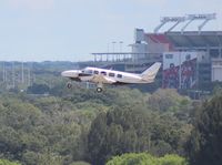 N100P @ TPA - PA-31-350 taking off at Tampa with Raymond James (Tampa Bay Buccaneers NFL team) Stadium in background - by Florida Metal