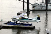 D-FVIP @ N.A. - Beaver floatplane in the harbour of Hamburg (St. Pauli Landungsbrücke), painted in the colours of a coffee brand. It was used for sight-seeing flights. It crashed in an emergency landing on 2 july 2006. - by Henk van Capelle