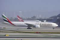 A6-ECK @ KLAX - Emirates 77W taxiing to TBIT whilst Qantas Airways A388 is docked at the new TBIT gates. - by speedbrds
