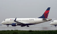 N874RW @ KCMH - A Delta Connection ERJ sits it out at a remote corner on a very wet day in Columbus. - by Daniel L. Berek