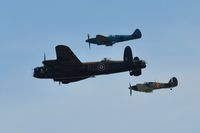 PM631 - Off airport. Five Merlins and a Griffon. One of the BBMF's R-R Griffon powered Spitfire PR. XIX aircraft in formation with Avro Lancaster B.I PA474 coded KC-A and Hurricane II.c LF363 coded YB-W. Displaying on the first day of the Wales National Air Show, - by Roger Winser