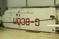 G-BCOM @ EGKA - wings off Piper J3C-65 Cub stored in a hangar at Shorham - by Chris Hall