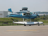 C-FMTZ @ CYKZ - 1957 Cessna 180A in its blue paint job with the Buttonville Control Tower in the background - by Ron Coates