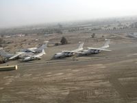 5A-DNC @ OMRK - 4 Il-76 and an An-12 at the airfield of Ras Al Khaimah (RKT) in the UAE - by Paul H