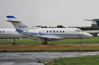 M-SAPT @ EGHH - Parked in the drizzle at Jetworks - by John Coates