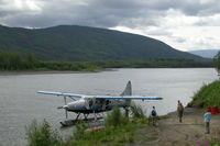 C-GMCW - Loading along the Stewart River in the Yukon. - by Murray Lundberg