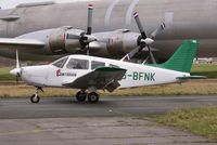G-BFNK @ EGHH - Taxies past the CL44 - by John Coates