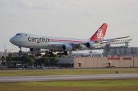 LX-VCB @ MIA - Cargolux 747-800 with the famous El Dorado Furniture building in the background, where a majority of MIA arrival shots are taken from - by Florida Metal