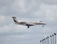 N322QS @ MIA - Net Jets Phenom 300 - by Florida Metal