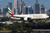A6-ECR @ SYD - Emirates B777-300 on approach to Sydney with the city skyline in the bakground - by mt334