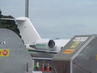 N604AU @ NZAA - I'm hiding behind the cargo trailers trying not to be seen. Shame the angles were all wrong on this nice green and yellow jet. - by magnaman
