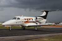 N999TN @ LAL - Phenom 100 with approaching storm - by Florida Metal