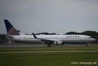 N66828 @ KSRQ - United Flight 1559 (N66828) arrives at Sarasota-Bradenton International Airport after being diverted from Tampa International Airport due to weather - by Donten Photography