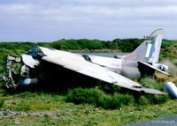 XV786 @ EGDO - Scanned from a print. The remnants of Harrier GR.3 XV786 lie in the Fire Training School at Predannack, Cornwall in 1997. Coded 'S' this a/c had been in use at the SFDO at nearby RNAS Culdrose - by Clive Pattle