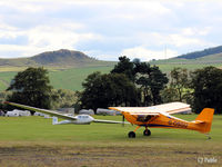 G-OSGU @ X6KR - Busy scene at Portmoak Gliding Field, Kinross, Scotland, 'GU taxies towards its hangar still trailing its glider tow line. - by Clive Pattle