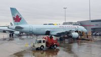 C-FFWM @ CYYZ - Air Canada Airbus A320 at the gate on a very rainy day. - by M.L. Jacobs
