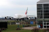 A6-EDS @ EGCC - Manchester arrival - taxy to the gate past the Restaurant and Concorde Hangar - by Clive Pattle