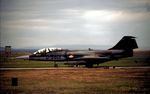 D-5801 @ EGQS - Royal Netherlands Air Force CAV TF-104G Starfighter leaving the active runway at RAF Lossiemouth in the Summer of 1982. - by Peter Nicholson