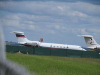 N300K @ NZAA - shot through wire fence amongst gaggle of biz stored on ramp for christmas - by magnaman