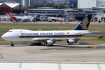 9V-SFN @ YSSY - TAXIING TO CARGO BAYS - by Bill Mallinson