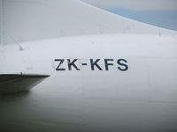 ZK-KFS @ NZAA - Flaky paint job!! - can still clearly see former ID of C-FKFS under current registration. Cheap skates! - by magnaman