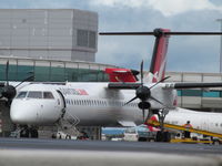 VH-QOF @ YBBN - in background behind a very annoyingly anonymous partner aircraft - by magnaman