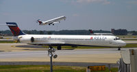 N906DA @ KATL - Taxi Atlanta, N676CA taking off - by Ronald Barker