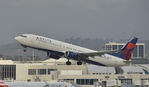 N821DN @ KLAX - Departing LAX on 25R - by Todd Royer