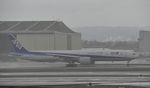 JA736A @ KLAX - Departing LAX in the rain - by Todd Royer