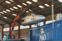 XG766 @ EGFH - The forward fuselage of an ex-RN, ex-RAN aircraft being lifted out of the container in DHA's hangar. The aircraft was coded 874/NW in RAN service when operated by 724 Squadron at Nowra, Australia. On 19/05/2000 the airframe was registered G-SPDR. - by Roger Winser