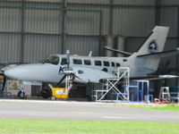 ZK-XLF @ NZHN - In hangar for work - long range photo from control tower area - by magnaman