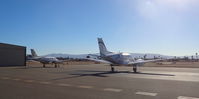 N12GJ @ KRHV - Locally-based 1972 Beechcraft King Air E-90 sitting on the ramp while another local King Air C90B taxis out for departure at Reid Hillview Airport, San Jose, CA. - by Chris Leipelt