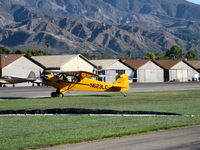 N623LC @ SZP - 2006 American Legend Aircraft AL3C-100 CUB, Continental O-200 100 Hp open lower cowl version S-LSA, taxi off Rwy 22L grass after  STOL landing. Unrelated tow banner on grass in foreground. - by Doug Robertson