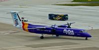 G-JEDU @ EDDL - Flybe, is here racing a bus and a tractor on the apron at Düsseldorf Int'l(EDDL) - by A. Gendorf