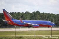 N215WN @ KRSW - Southwest Flight 371 (N215WN) arrives at Southwest Florida International Airport following flight from Akron-Canton Regional Airport - by Donten Photography