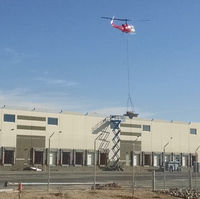 N214KK @ KTUS - N214KK lowering an HVAC unit at distribution facility roof, 1 mile NE of Tucson International Airport.