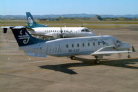 ZK-EAP @ NZAA - Beech 1900D [UE-439] (Air New Zealand Link/Eagle Airways) Auckland-Int'l~ZK 26/09/2004. Taken through glass of coach resulting in a bit of reflection. - by Ray Barber