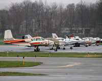 N3065D @ KCDW - A classic 1956 Cessna 310 heads a line-up of younger stablemates at CDW. - by Daniel L. Berek