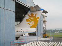 SE-DJO @ EGTE - peeking out of maintenance hangar - by magnaman