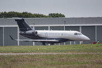 N721EE @ EGJB - Being lined up for an engine test at Guernsey. Long distance shot with some heat haze, unfortunately - by alanh