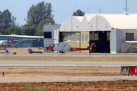 N107Z @ KRDD - 1983 Bell 209 (AH-IS Cobra) Firewatch Cobra C/N 22342 at Redding being pushed back into the hangar. - by Tom Vance