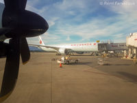 C-FNNU @ CYVR - Parked at International Terminal, shot from another plane. - by Remi Farvacque