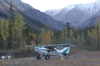C-GMUD - On the tiny airstrip parallel to the Alaska Highway at the Northern Rockies Lodge, Muncho Lake, BC. - by Murray Lundberg