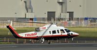G-TRMP @ EGAC - Departing after a very short visit – about five minutes. - by Albert Bridge