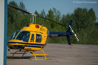C-FNTM @ CYYE - Parked outside Qwest Helicopters hangar - by Remi Farvacque