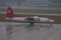 JA8875 @ RJNA - This Fokker 50 was operated by NAL and just arrived in a rain shower at Nagoya Komaki Airport