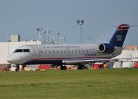 N244PS @ DAY - PSA Airlines Canadair Regional Jet CRJ-200ER {N244PS}, operating as U.S Airways Express, heads towards Runway 24 Left at the Dayton International Airport {DAY} bound for the Charlotte/Douglas International Airport on June 21, 2015. - by Rollie Puterbaugh 2015