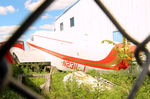 N231LJ @ JVL - N231LJ - much modified Beech 18 viewed in the grass through the fence between hangars where it soldiers on at Janesville, Southern Wisconsin - by Pete Hughes